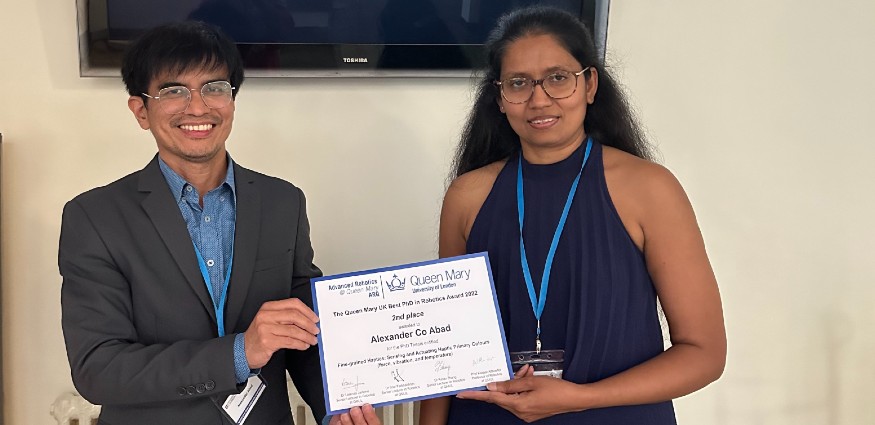 A man and women standing holding a certificate.